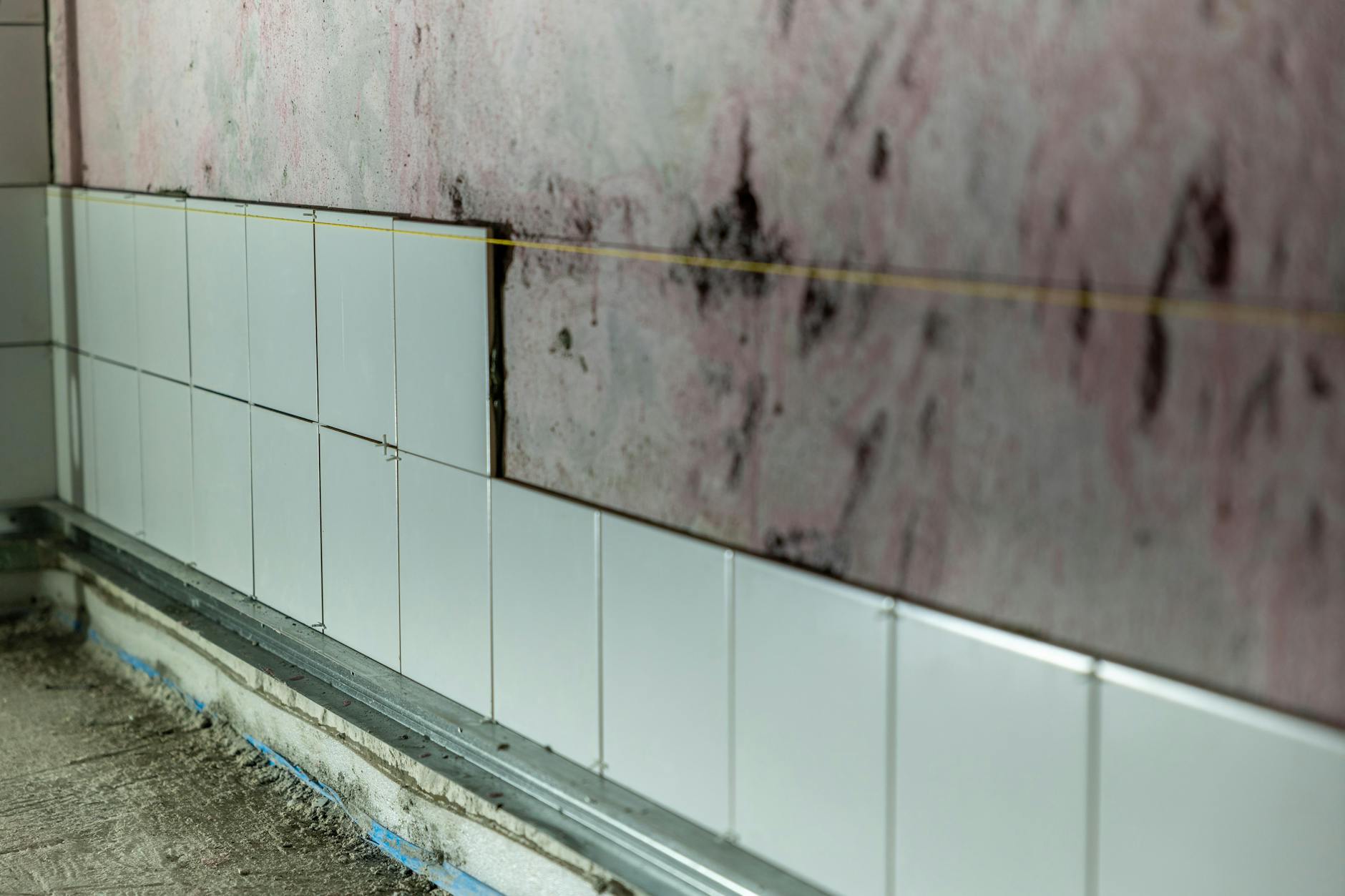 unfinished wall tiling in construction site