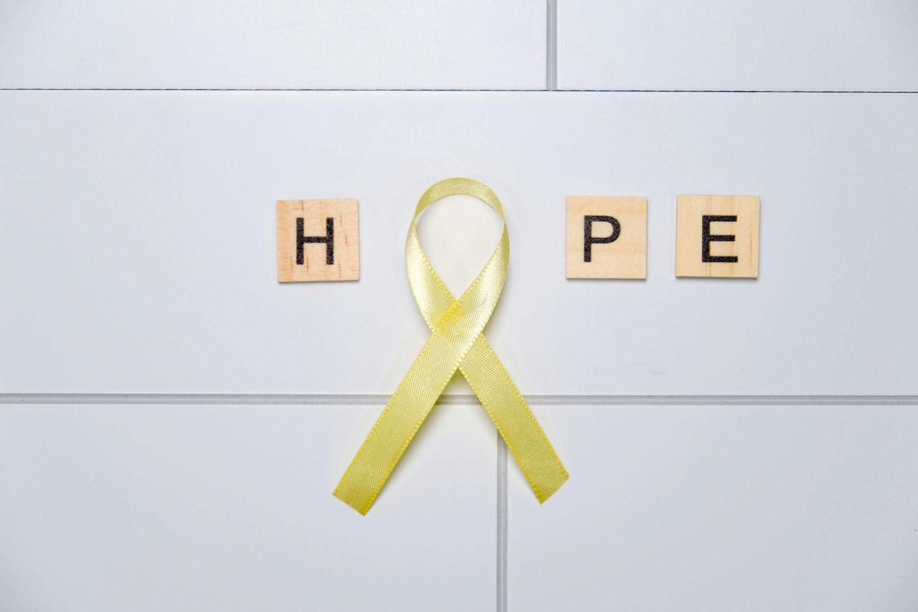 yellow ribbon hope on minimalist tile background