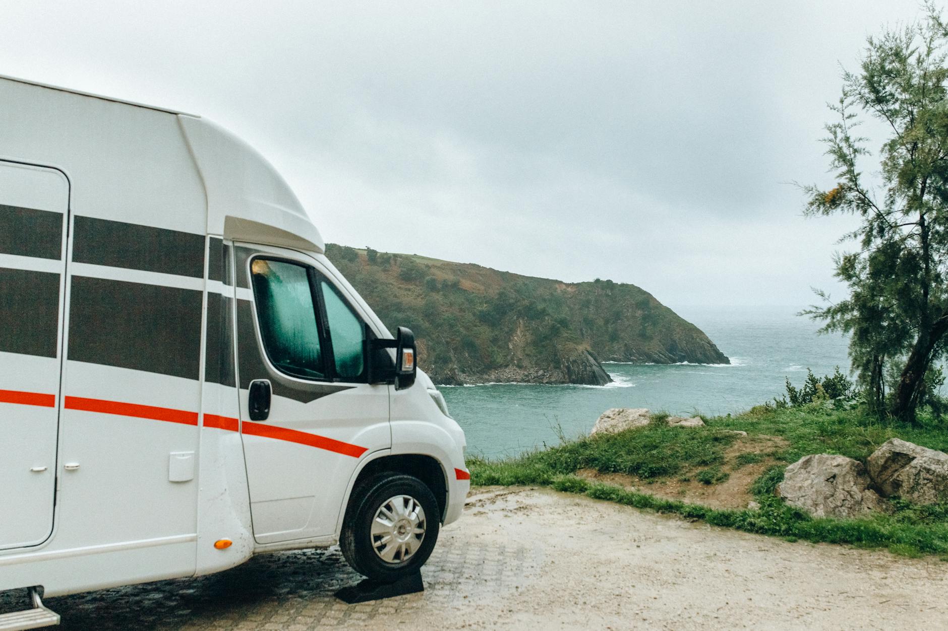 whte van parked on seaside