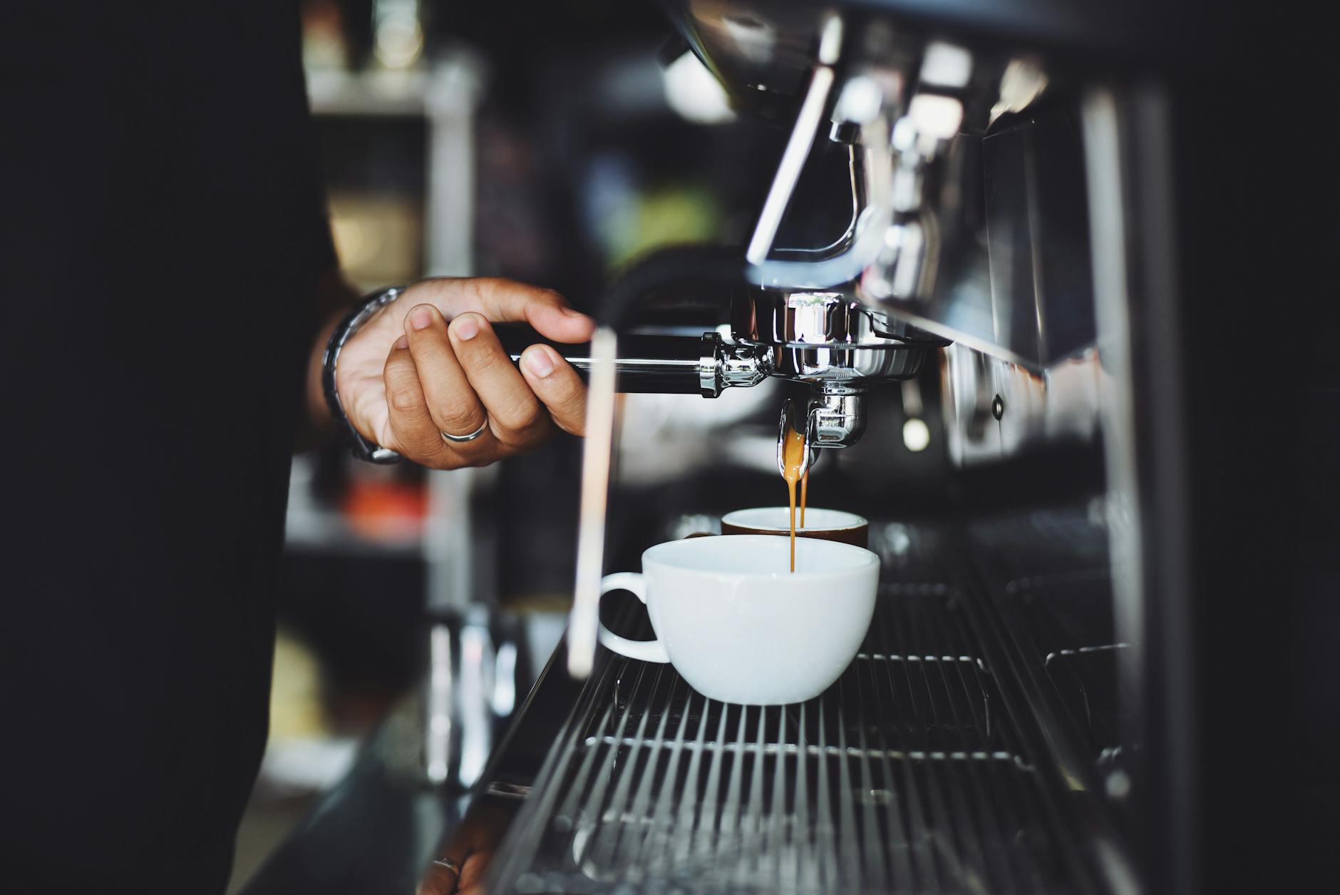 close up of hand holding coffee machine